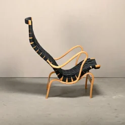 Pamono Set of Pernilla Easy Chair and Ottoman in Beech and Black Upholstery by Bruno Mathsson for Dux, 1970s Clearance